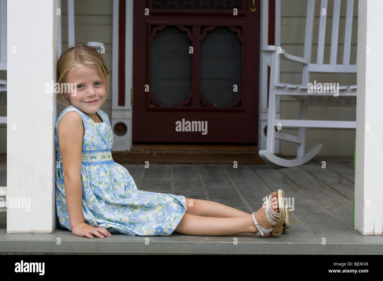 girl sitting on the front porch Stock Photo Alamy