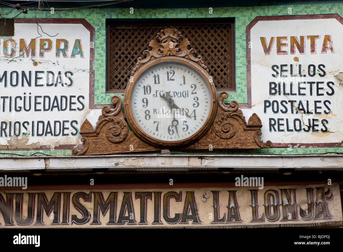 Old clock face above shop. Valencia, Valencia Province, Spain Stock Photo