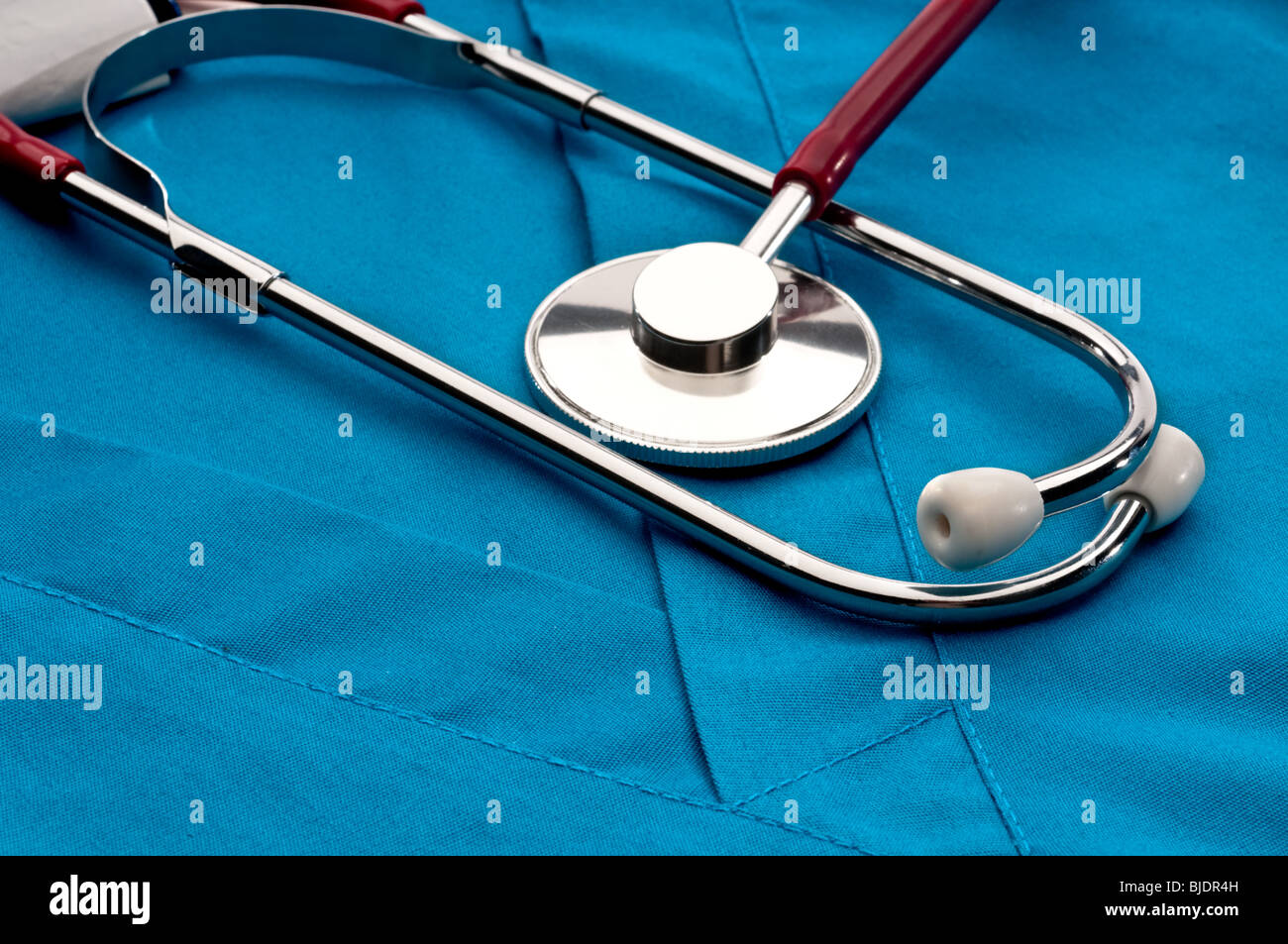 A stethoscope on blue doctor's medical scrubs Stock Photo