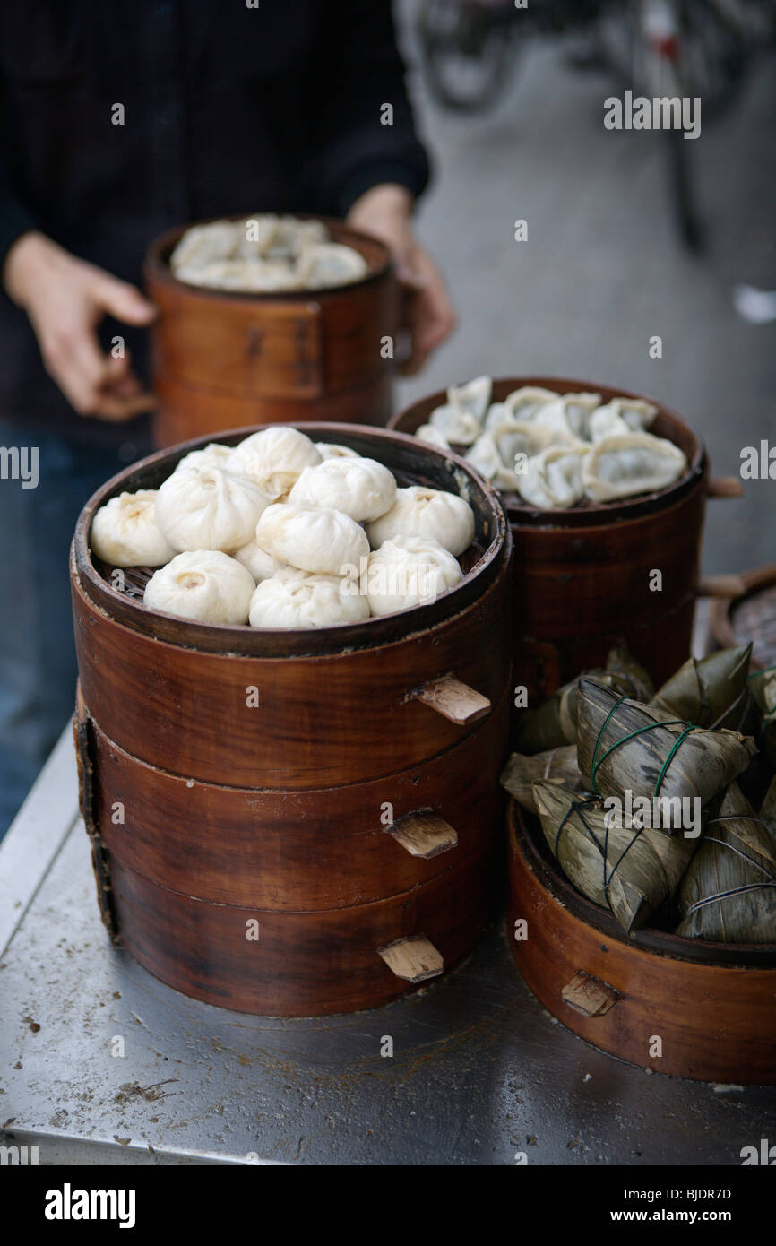 Chinese steamed dumplings (baozi and jiaozi) at a streetside restaurant