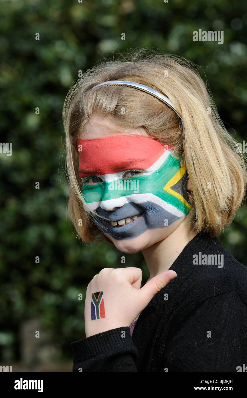 Portrait of a girl with face painted in the colours of the national flag of South Africa Stock Photo