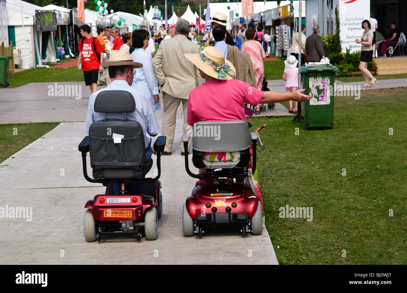 Man and woman on disability scooters at National Eisteddfod of Wales