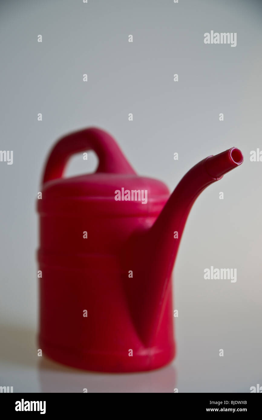Red Watering Can Stock Photo - Alamy
