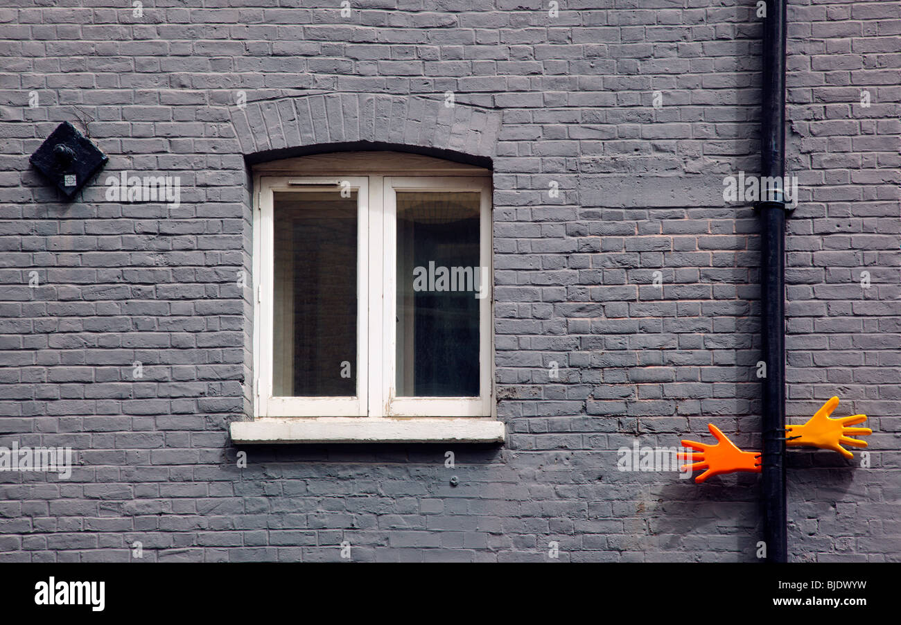 Plastic hands on brick walls in Southwark London England UK Stock Photo