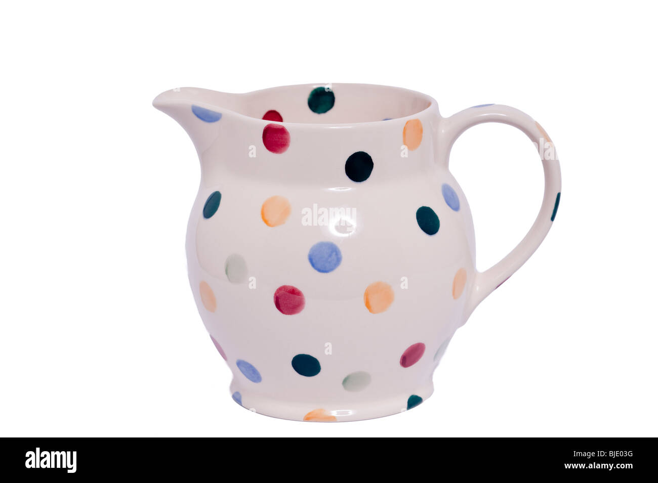 A Polka dot patterned jug by Emma Bridgewater decorated by hand on a white background Stock Photo