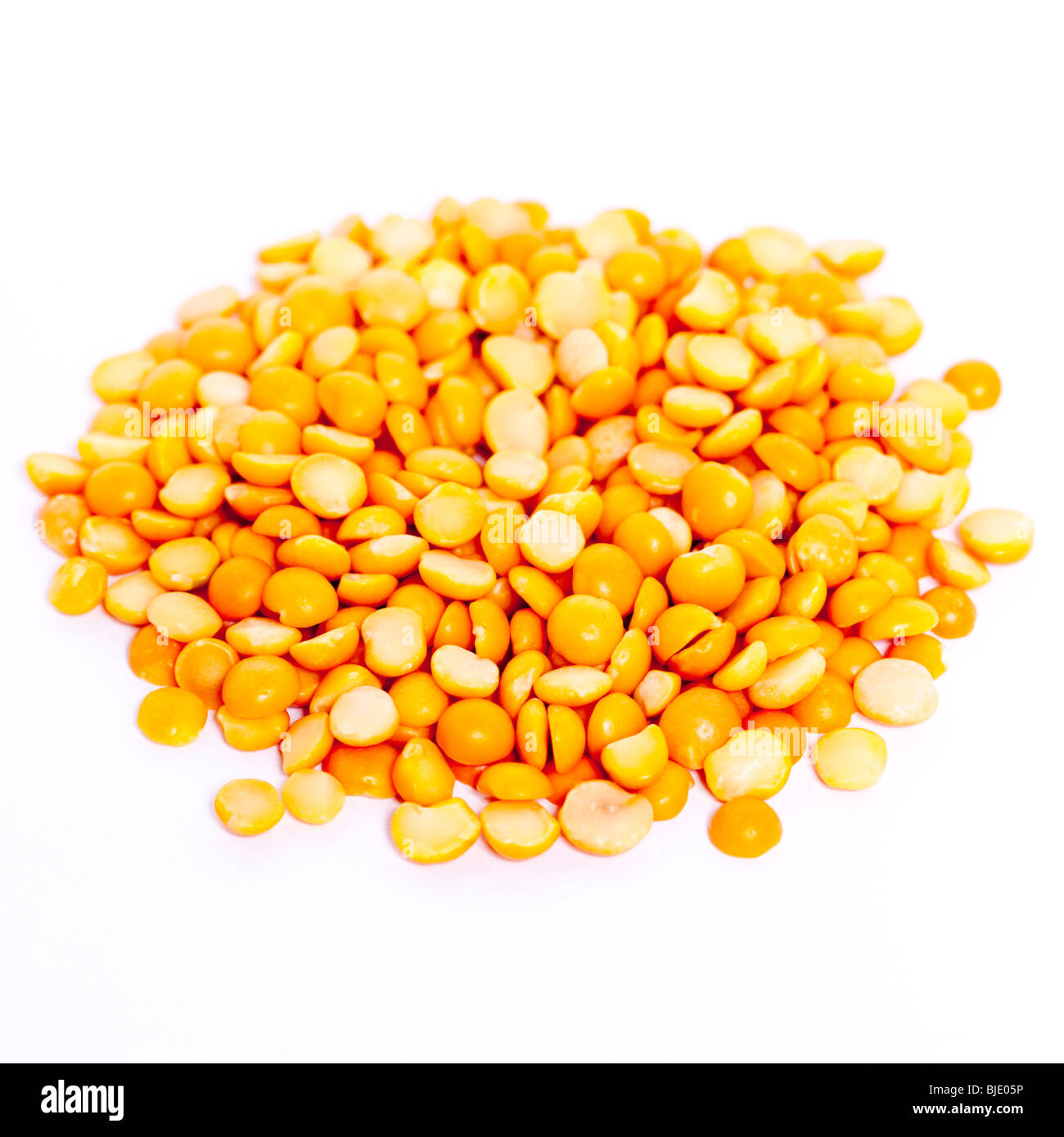 A pile of uncooked yellow split peas on a white background Stock Photo