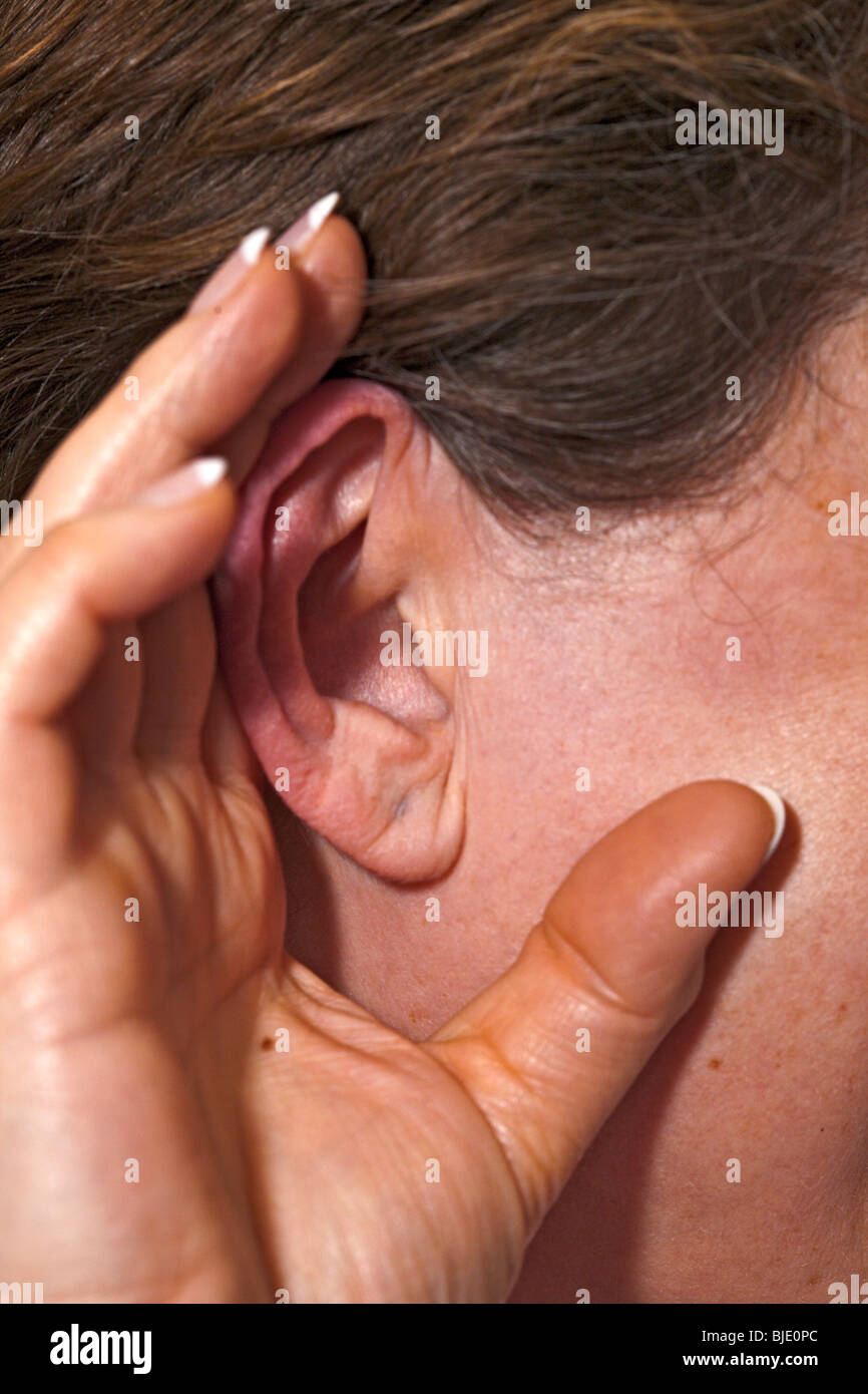 listening with cupped hand Stock Photo