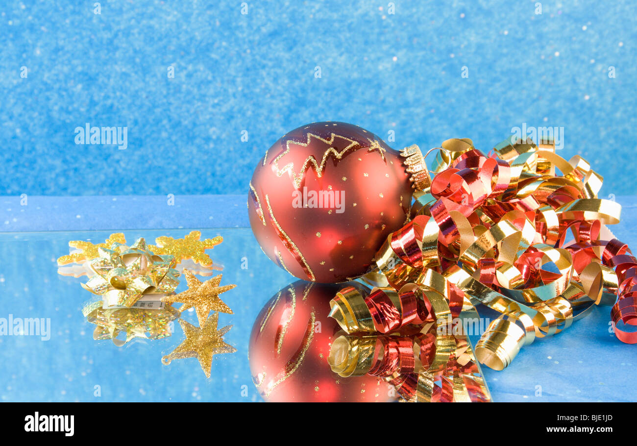 red and gold Christmas bauble, curly ribbon, gold star and bows Stock Photo