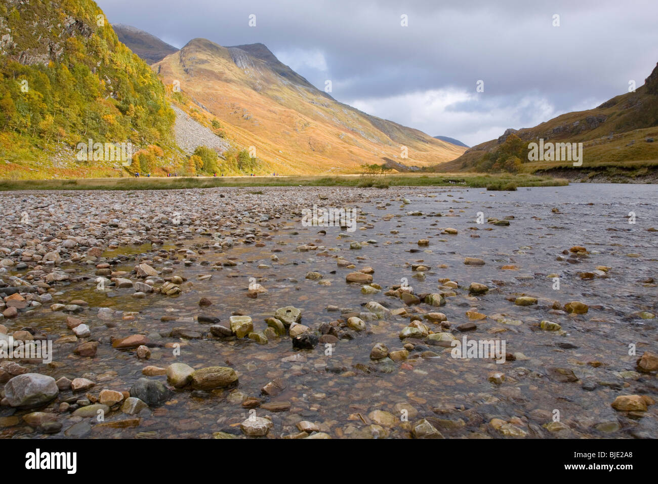 Glen Nevis, Highland, Scotland. View across the Water of Nevis to sunlit mountain slopes, autumn. Stock Photo