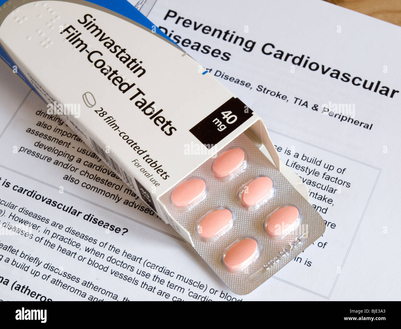 A box and a blister pack of Statin tablets on a leaflet about Cardiovascular heart disease Stock Photo