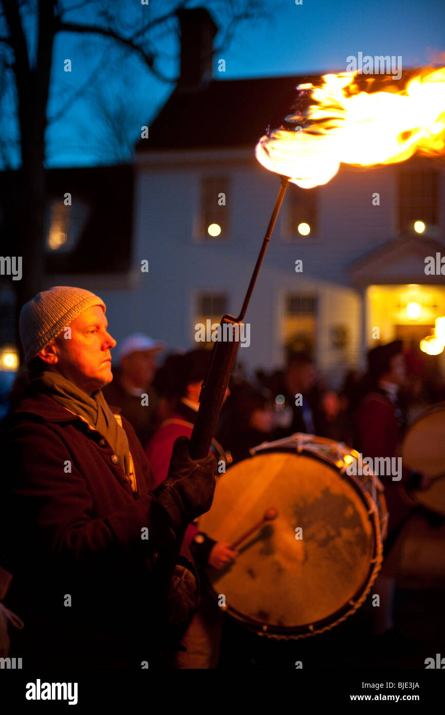 A man carrying a flaming torch during the Christmas parade at Colonial Williamsburg, Virginia, USA Stock Photo