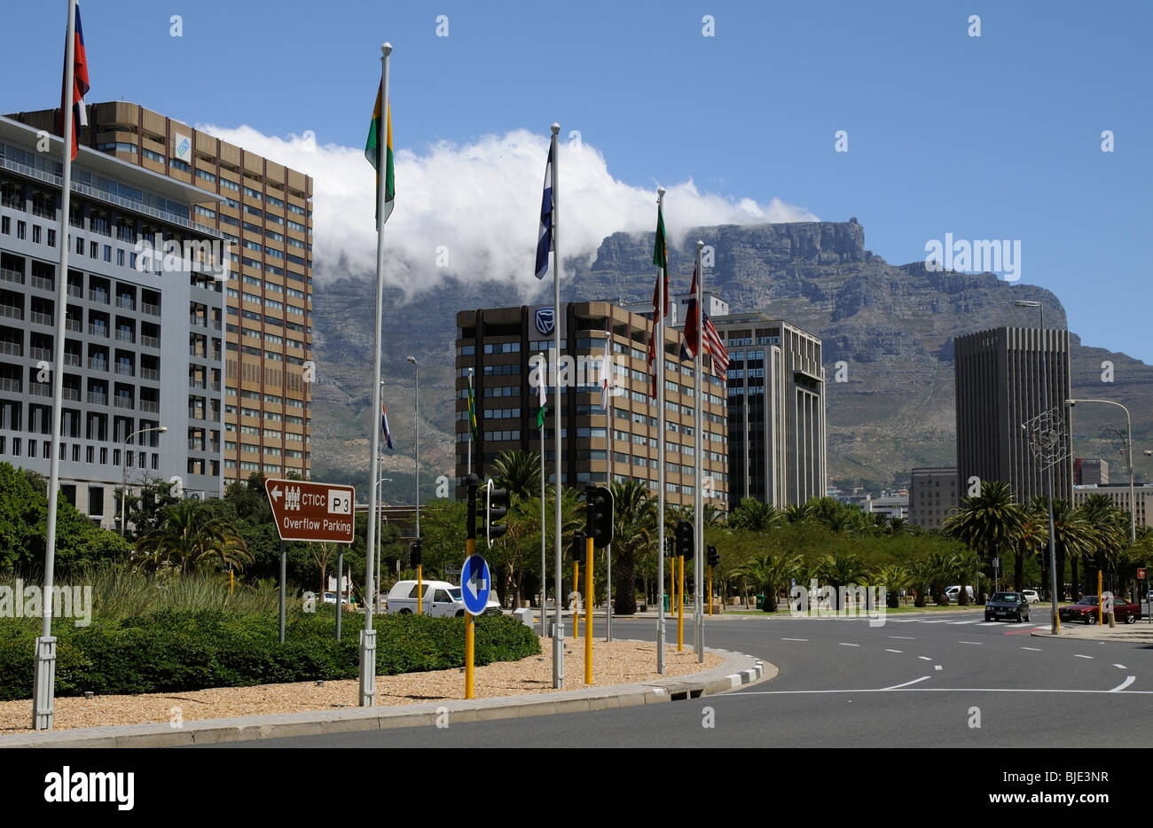 Table Mountain with cloud gathering overlooks the office premises along Adderley Street in Cape Town's city centre. South Africa Stock Photo