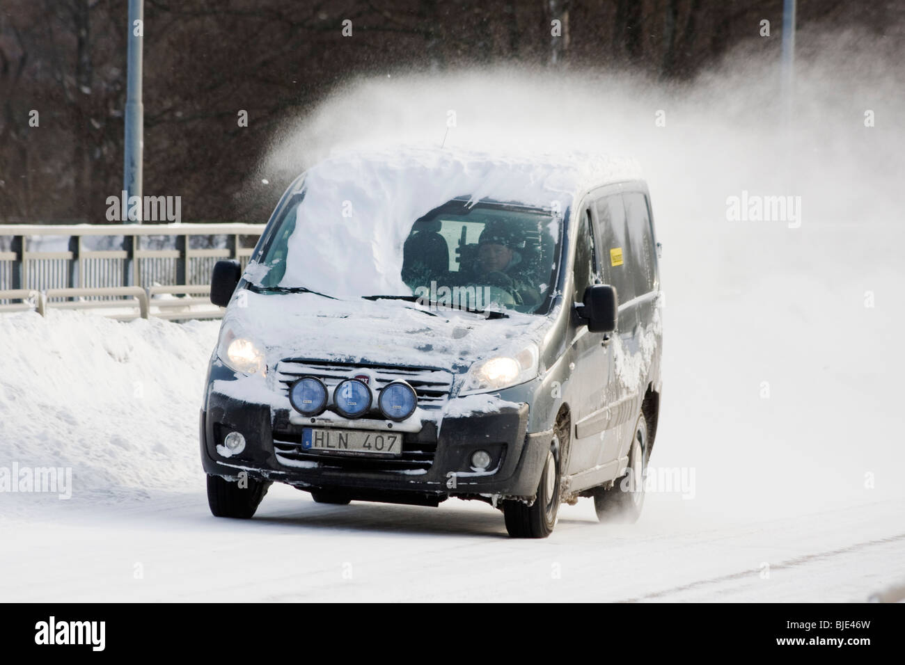 Man driving a minivan with snow on the windshield Stock Photo