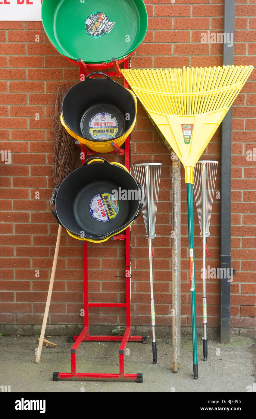 hardware and garden tools on display for sale outside a shop in