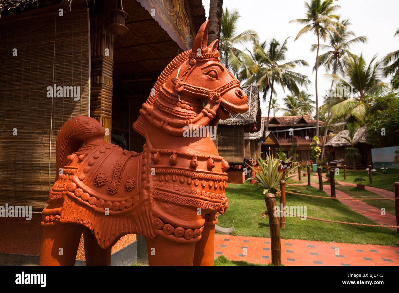 India, Kerala, Varkala, terracotta horse amongst clifftop tourist accommodation made from natural materials Stock Photo
