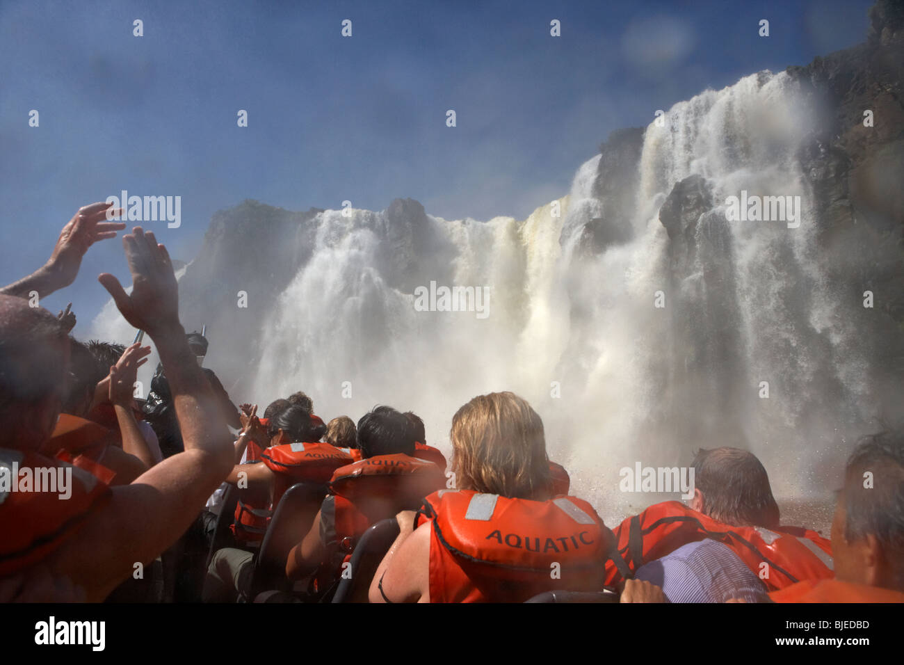 group of tourists getting soaked on speedboat underneath the mbigua fall waterfalls iguazu national park republic of argentina Stock Photo