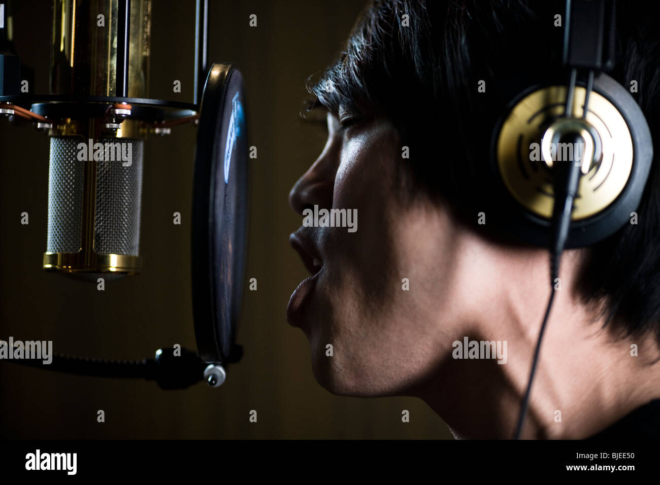 singing in a recording studio Stock Photo