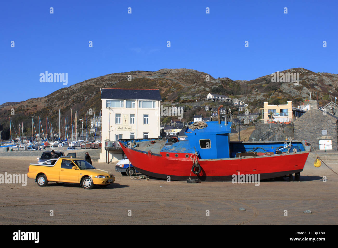 Boat being repaired in Barmouth harbour at low tide. Stock Photo