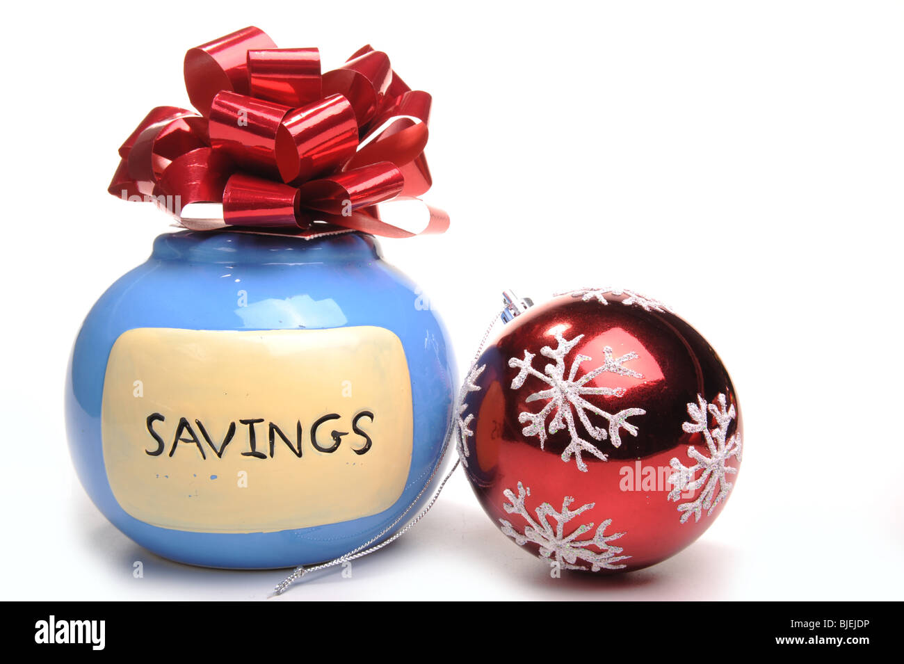 Money Box with bow on top and a red Christmas Bauble Stock Photo