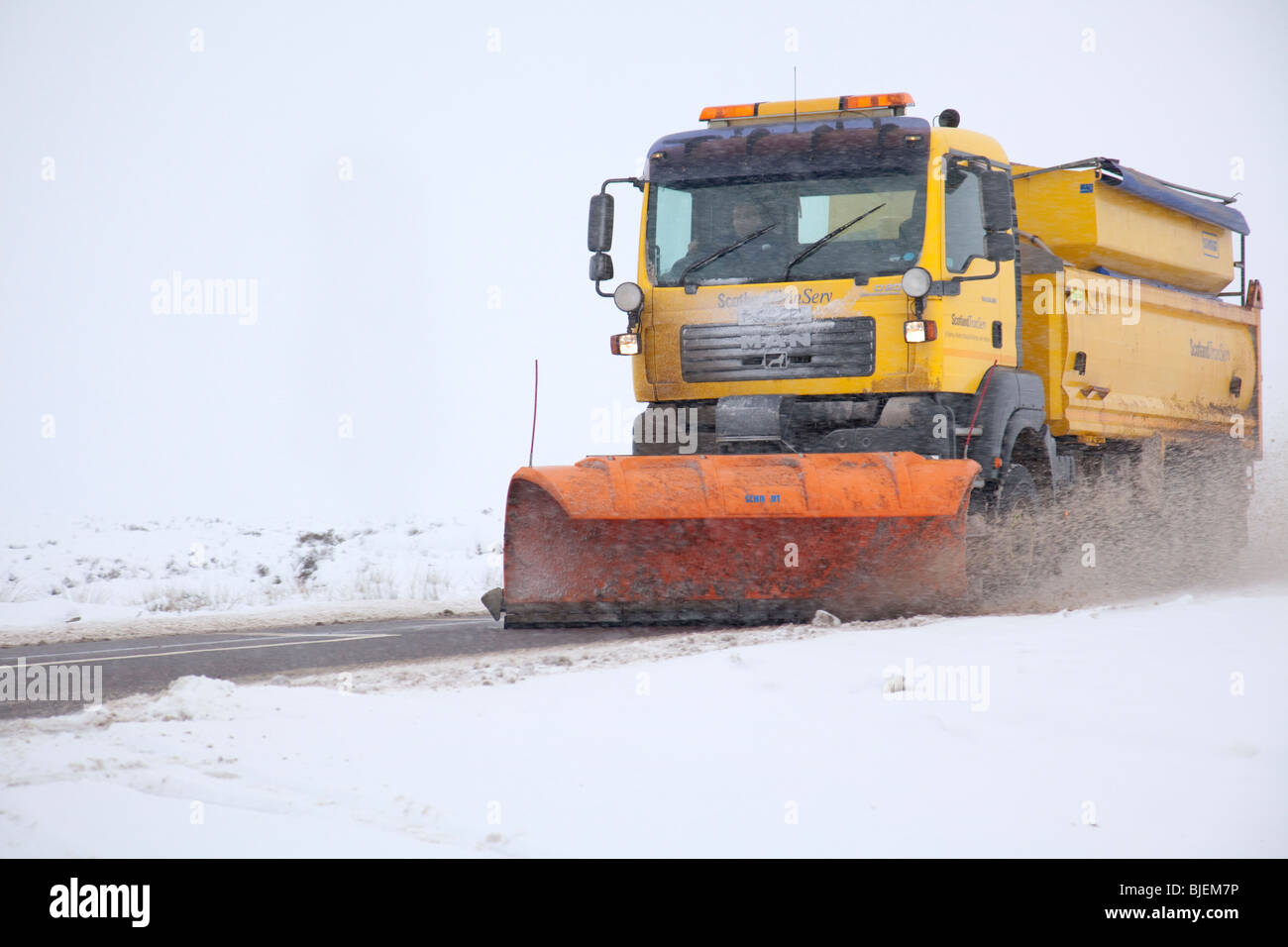 Snow plough clearing road on A82 Scotland Stock Photo Alamy