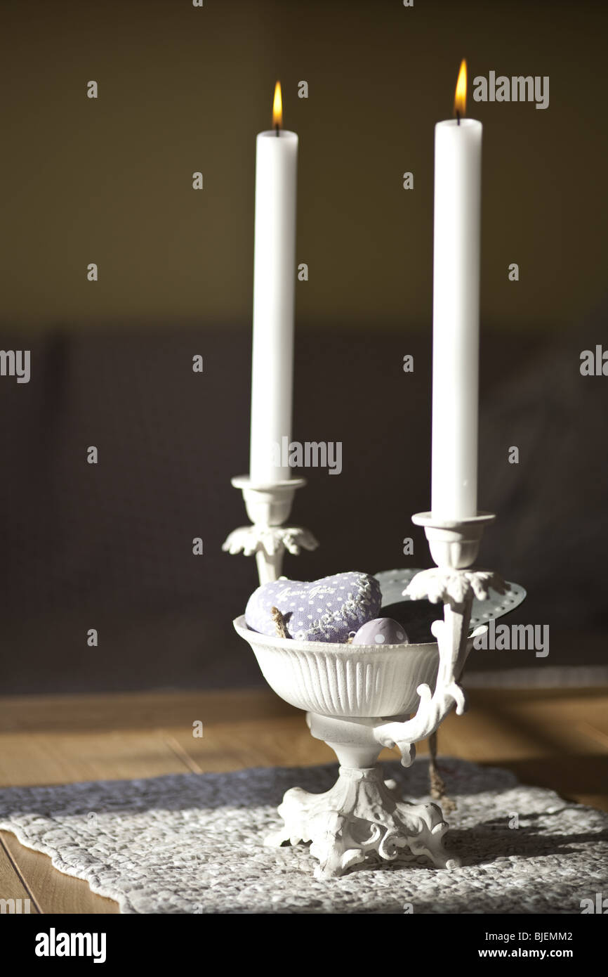 Candleholder with candles on a table, close-up Stock Photo