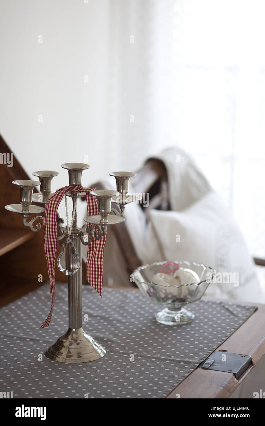 Candleholder and small bowl on a table Stock Photo