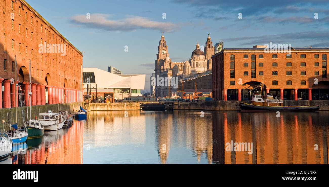 The Albert Dock with the Three Graces in the Background, Liverpool, Merseyside, England, UK Stock Photo