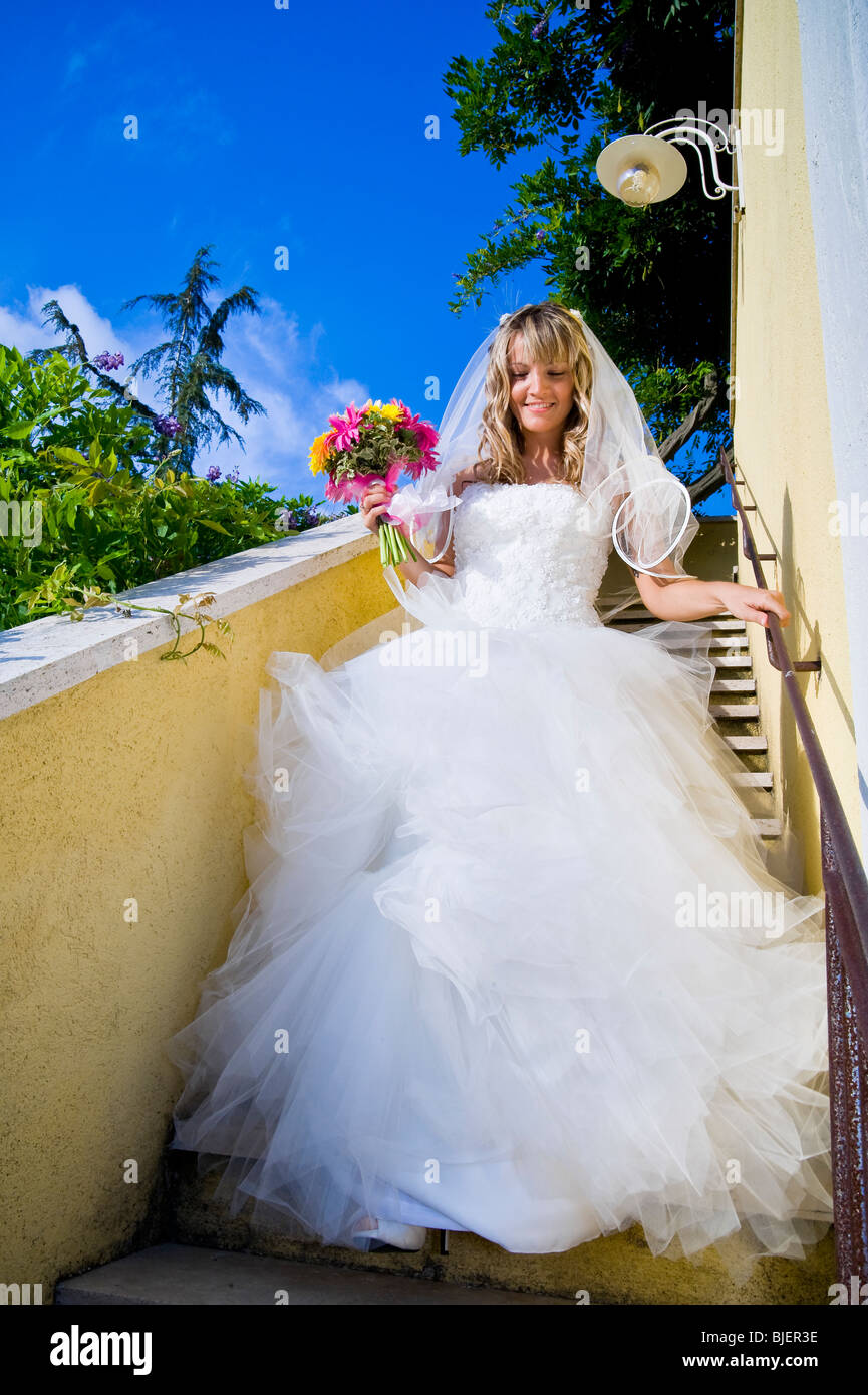 Bride walking down stairs in hi-res stock photography and images - Alamy