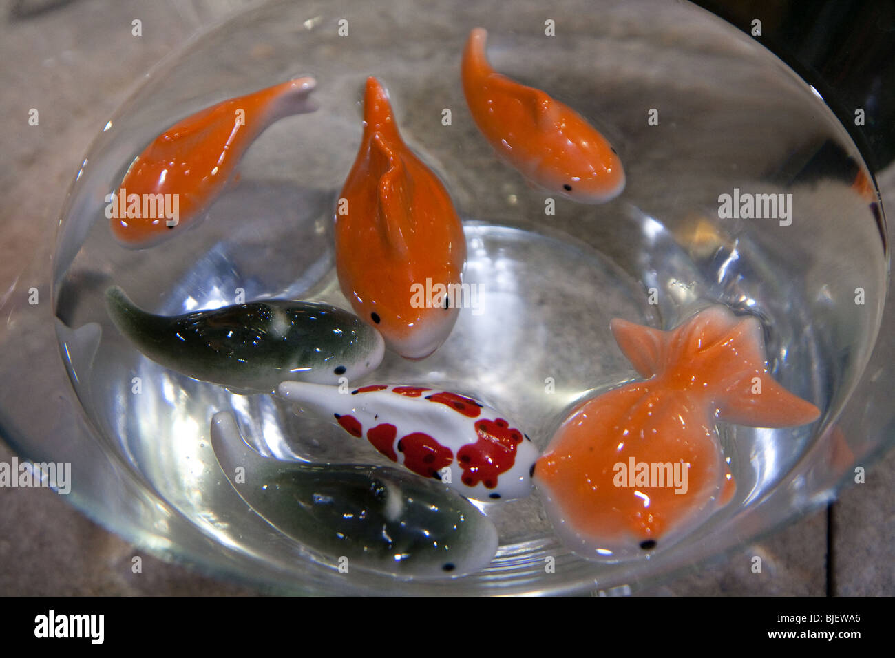 gold fish toy floating water glass bowl Stock Photo