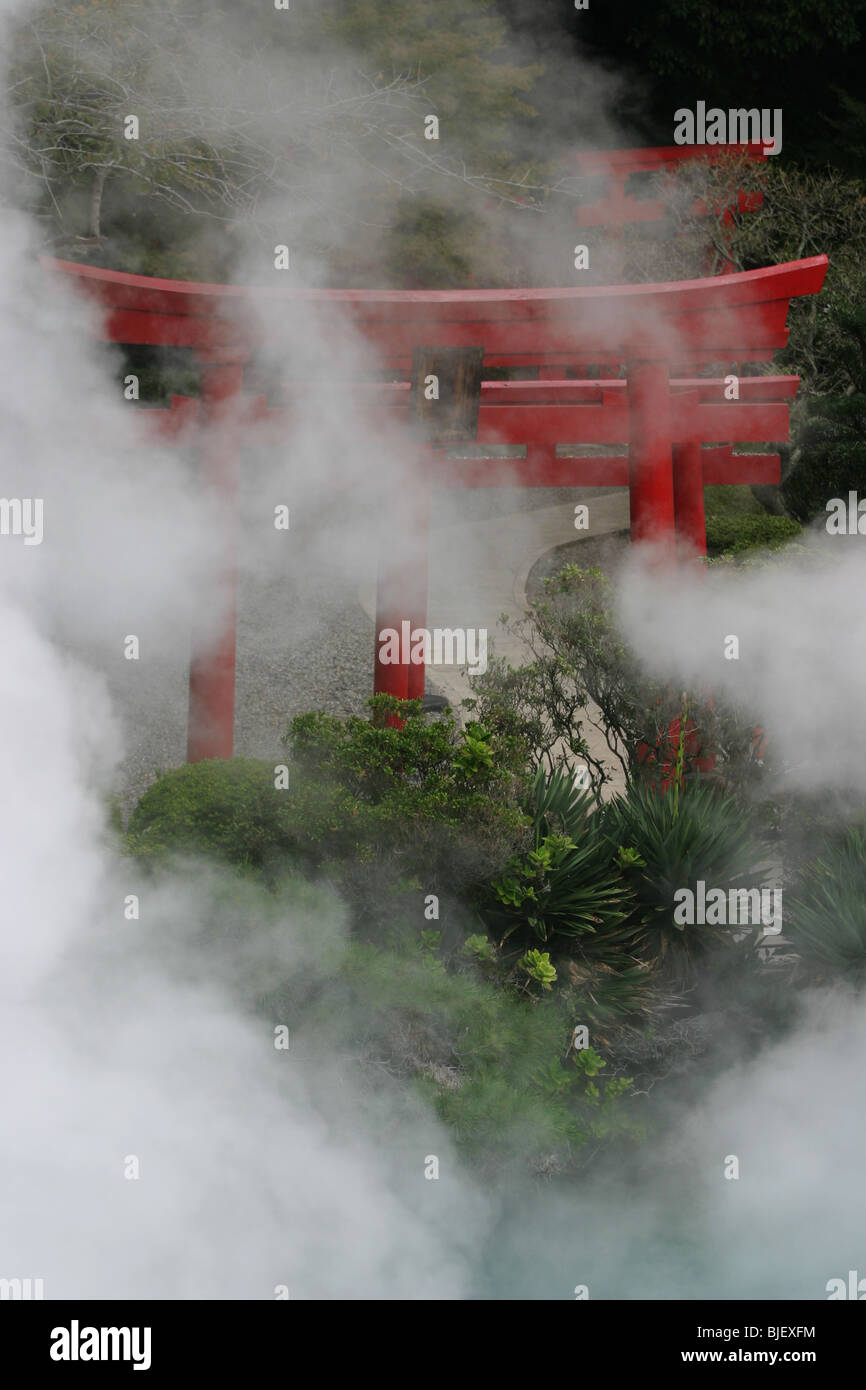 The red 'Torii' gates of a shinto shrine, stand beside a volcanic water ...
