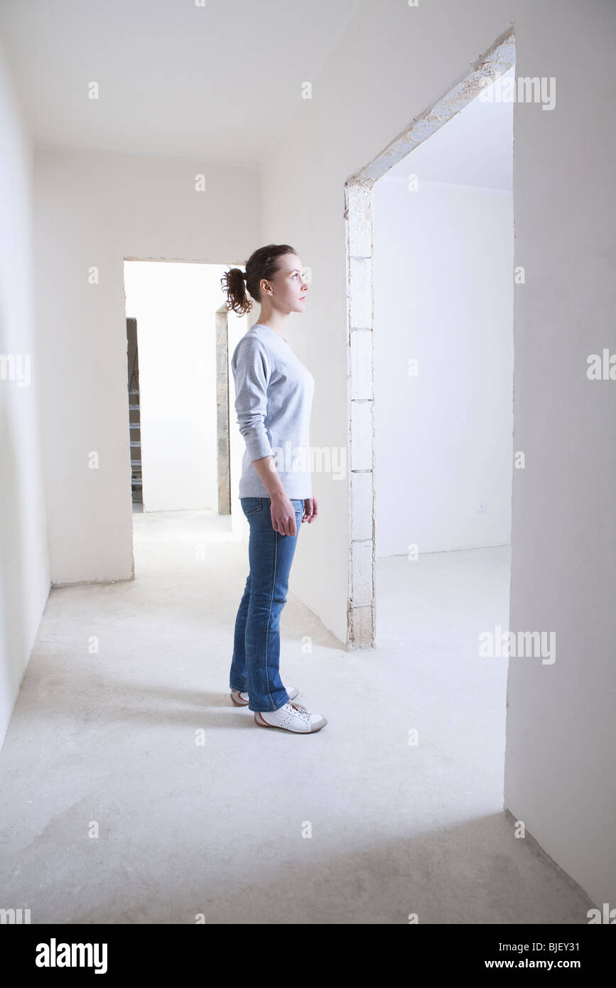 Woman stands in hallway of new apartment Stock Photo - Alamy