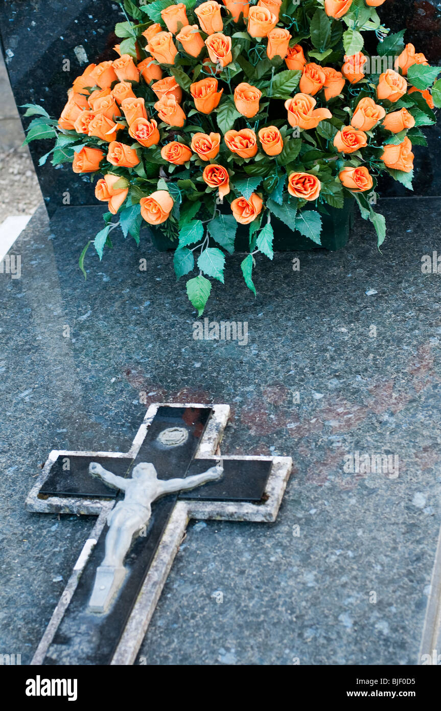 Flowers on a catholic tombstone Stock Photo
