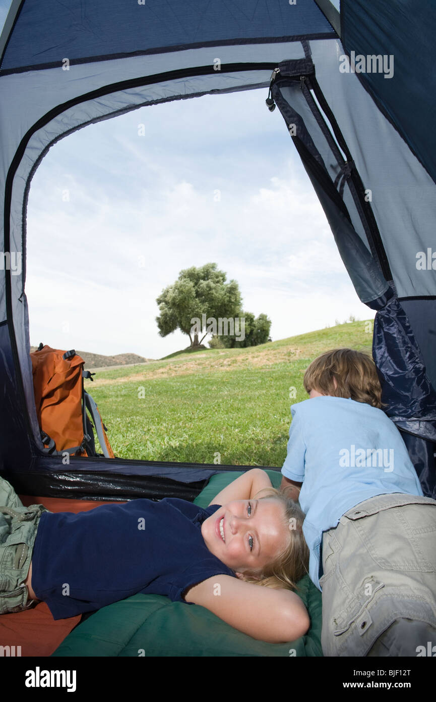 Brother and sister lie in a tent Stock Photo - Alamy