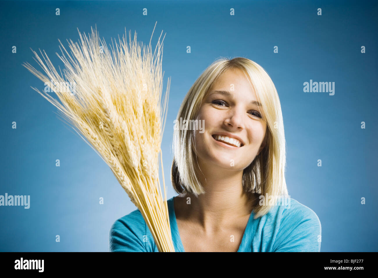 woman holding up wheat Stock Photo - Alamy