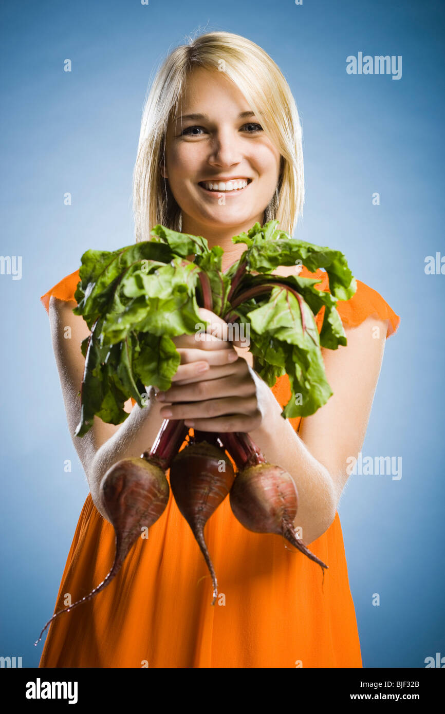 woman holding radishes Stock Photo