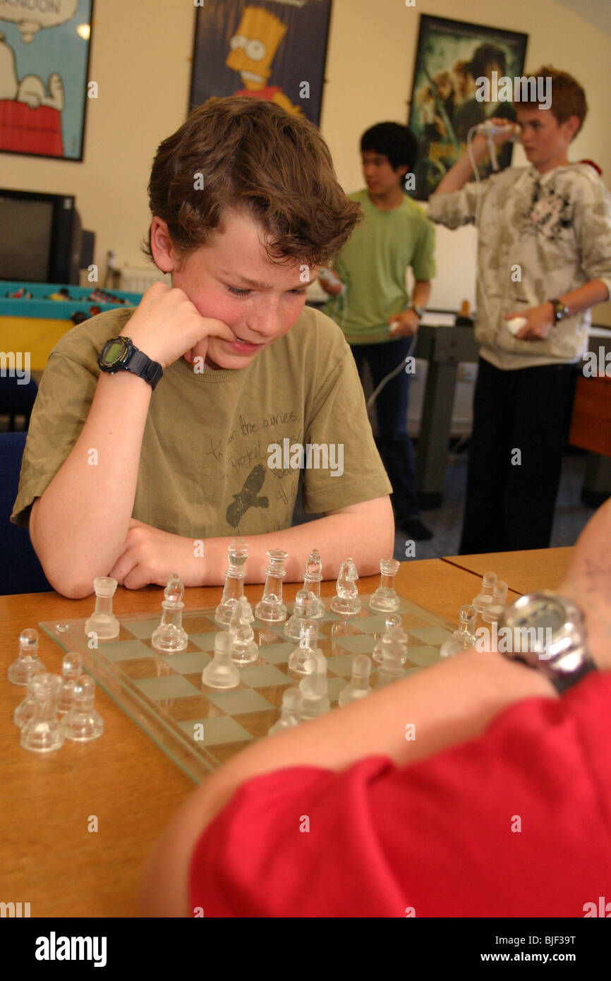 Two young boys playing chess together Stock Photo