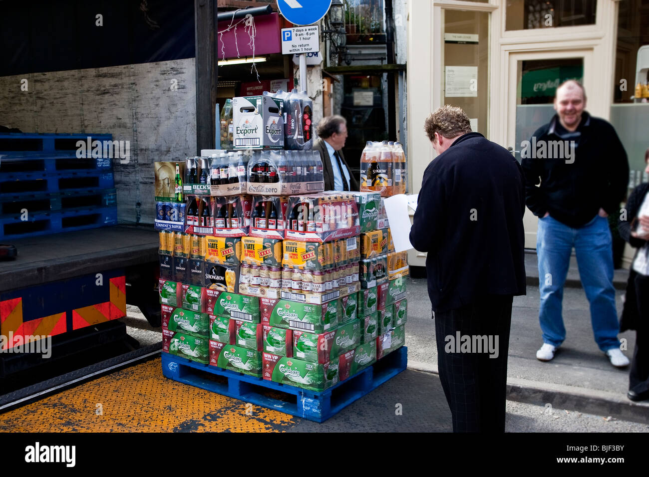 Checking a delivery of drinks at an off license Stock Photo Alamy