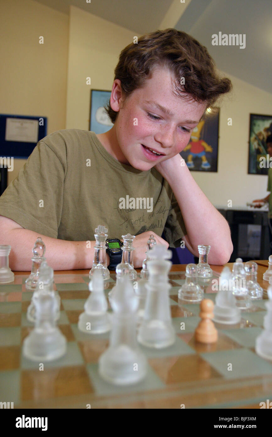 Two young boys playing chess together Stock Photo