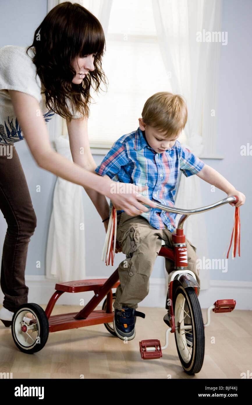 boy riding tricycle