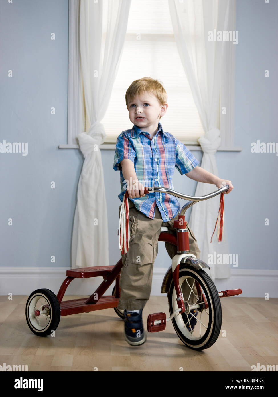 boy riding tricycle