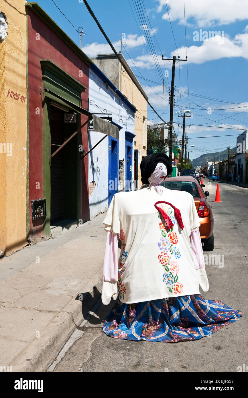 buxom winsome dummy in folkloric blouse & skirt saves parking space saver outside market on Calle Rayon in Oaxaca City Mexico Stock Photo