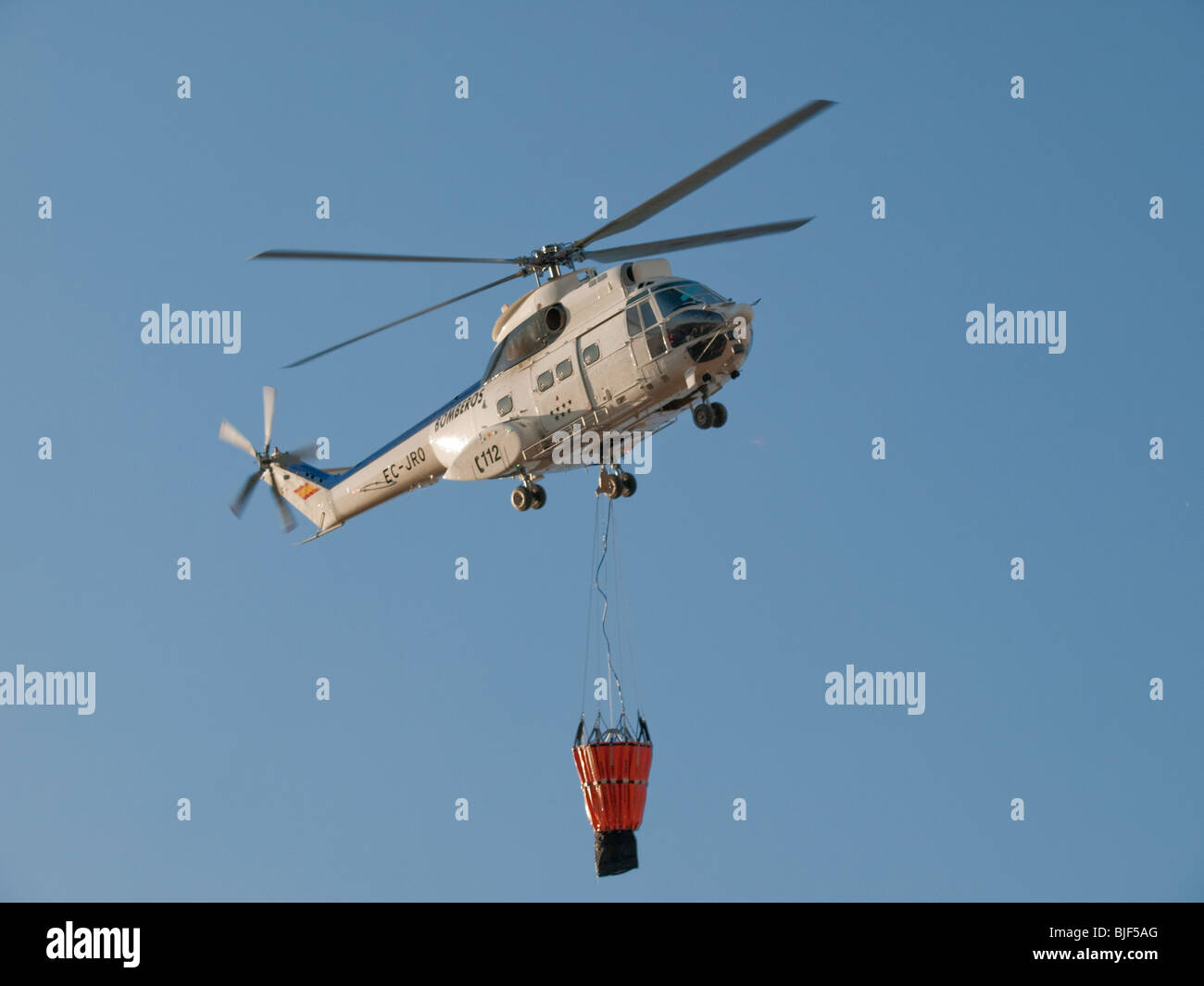 Fire fighting helicopter carrying water bag Stock Photo - Alamy