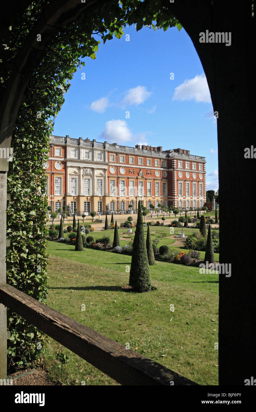 View through hedge covered walkway of the Privy Garden towards Hampton Court Palace, Richmond Upon Thames, UK. Stock Photo