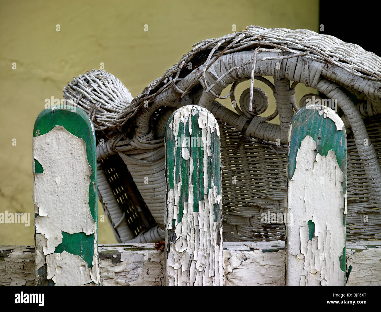 Old Weathered Paint Peeling Fence and Wicker Chair Detail, Lancaster Pennsylvania USA Stock Photo