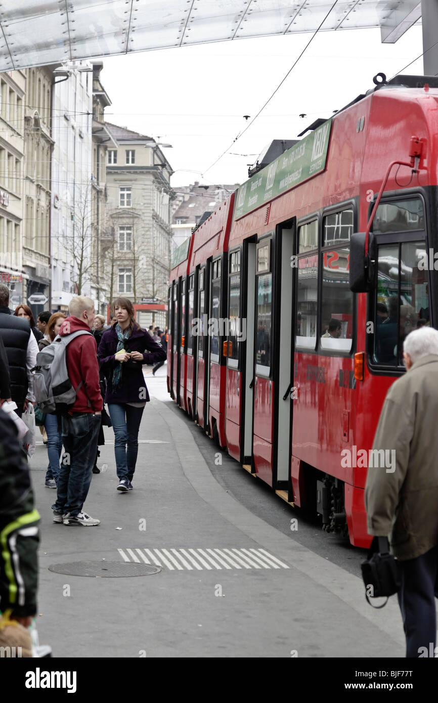 Passengers walking down tram platform as tram leaves the station, Bern Switzerland. Charles Lupica Stock Photo