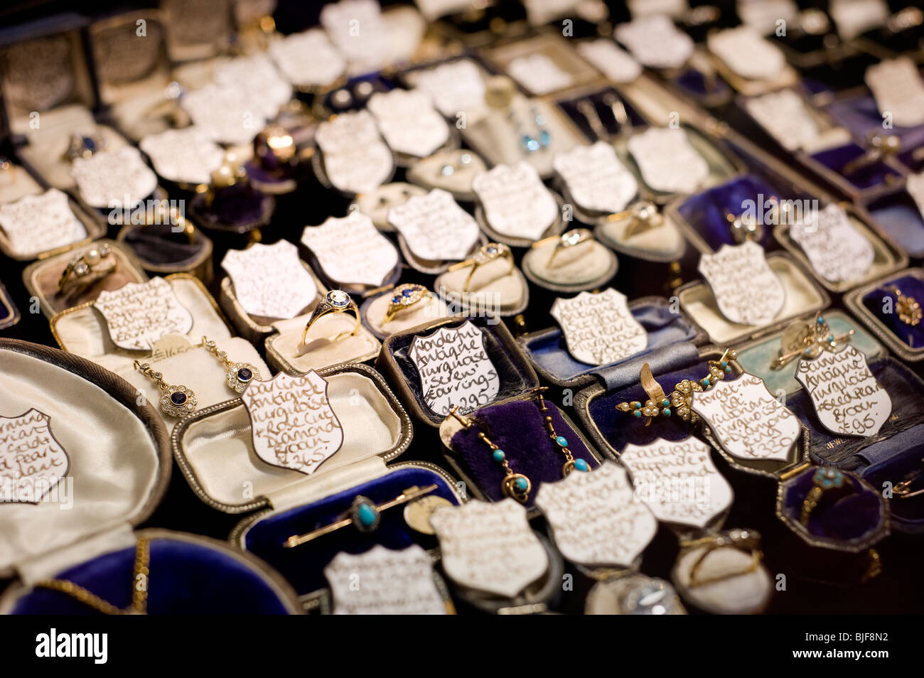 Closeup view of Vintage Jewellery inside a shop window in The Lanes, Brighton East Sussex England UK Stock Photo