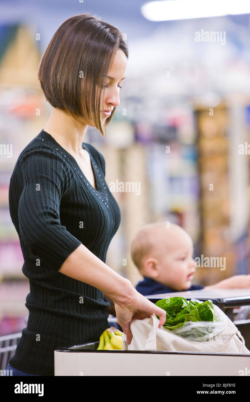 mother grocery shopping with baby Stock Photo