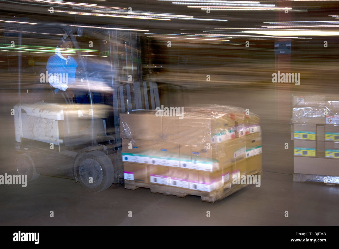 Warehouse Worker On Forklift Moving Boxes, Philadelphia, USA Stock
