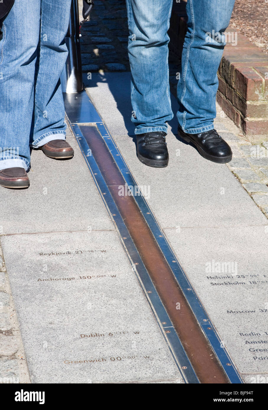 Tourists on the Greenwich Prime Meridian Line 0 Degrees Longitude Stock Photo