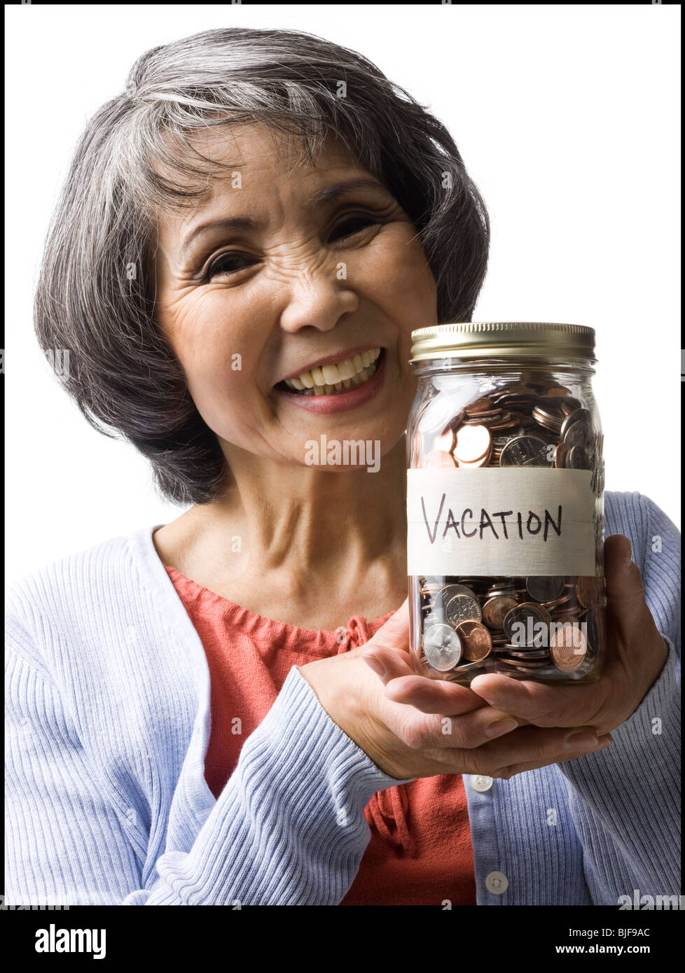 woman with a jar full of coins Stock Photo